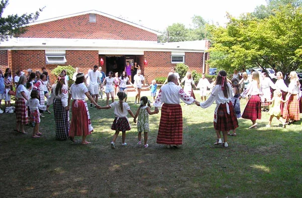 Беларускі карагод. На заднім пляне - Беларуска-амэрыканскі грамадзкі цэнтар у Саўт-Рывэры, пабудаваны ў 1975 г.