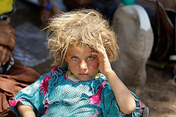 Девочка-езидка, бежавшая из иракского города Синджара, на пограничном пункте Фишхабур (иракско-сирийская граница), 13 августа 2014 Фото: Youssef Boudlal / Reuters